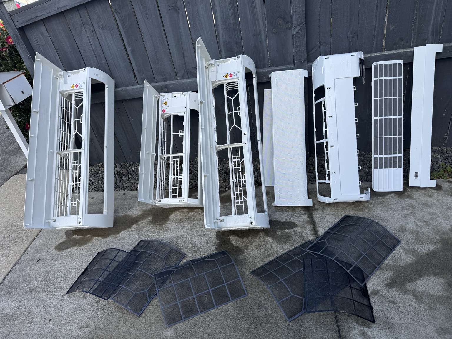 Heat pump covers and filters laid out after removal